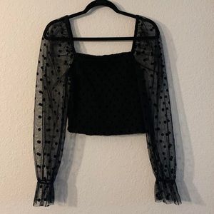 Sheer sleeve top with black velvet polka
dots
